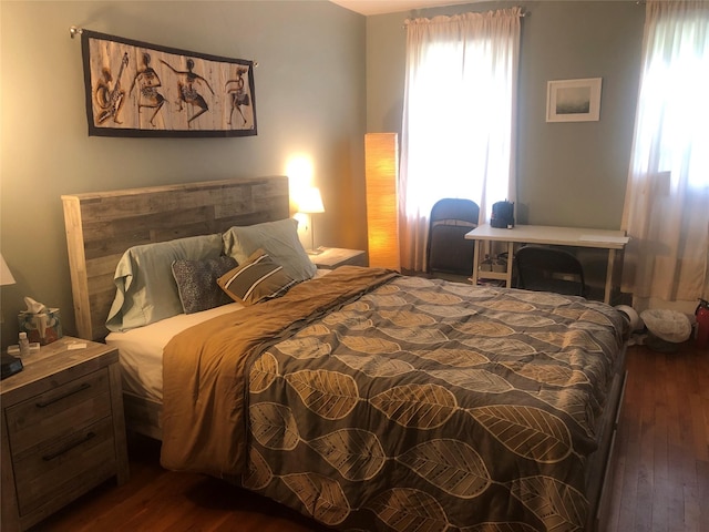 bedroom with dark hardwood / wood-style floors