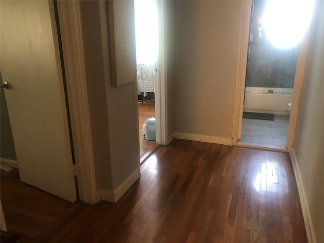 hallway with dark hardwood / wood-style floors