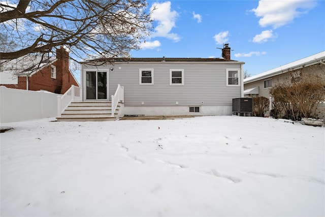 view of snow covered rear of property