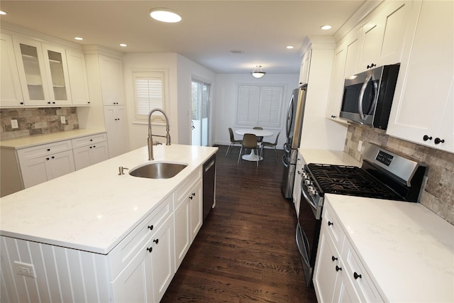 kitchen featuring light stone counters, sink, white cabinetry, and stainless steel appliances