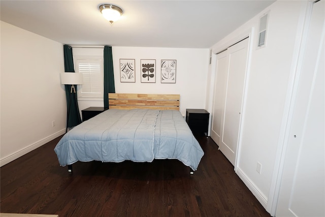 bedroom with a closet and dark wood-type flooring