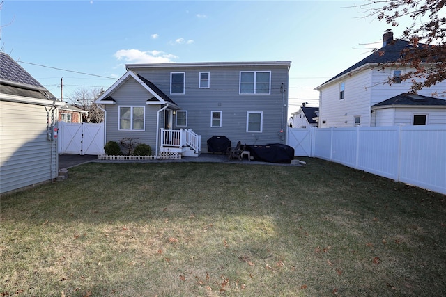 rear view of house with a yard