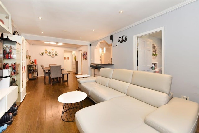 living room featuring ornamental molding and dark wood-type flooring