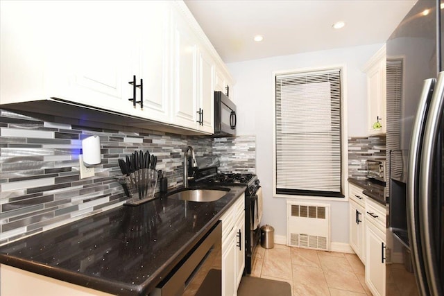 kitchen with radiator, sink, tasteful backsplash, black appliances, and white cabinets