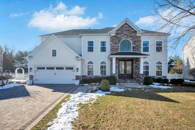 view of front of house featuring french doors, a garage, and a front lawn