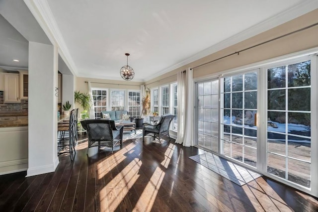 sunroom featuring a chandelier