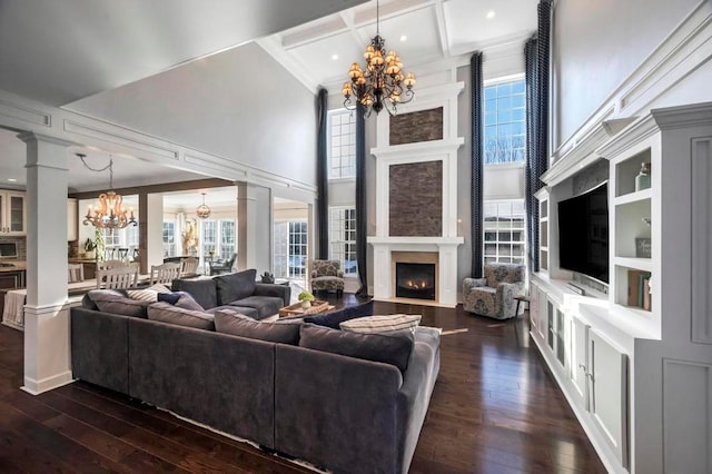 living room with ornate columns, beamed ceiling, dark hardwood / wood-style flooring, coffered ceiling, and a notable chandelier