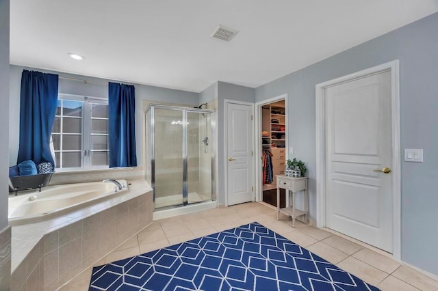 bathroom featuring tile patterned floors and separate shower and tub