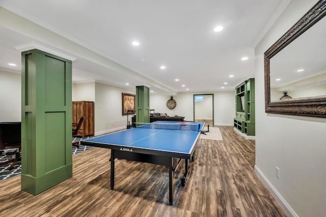 game room with wood-type flooring and ornamental molding