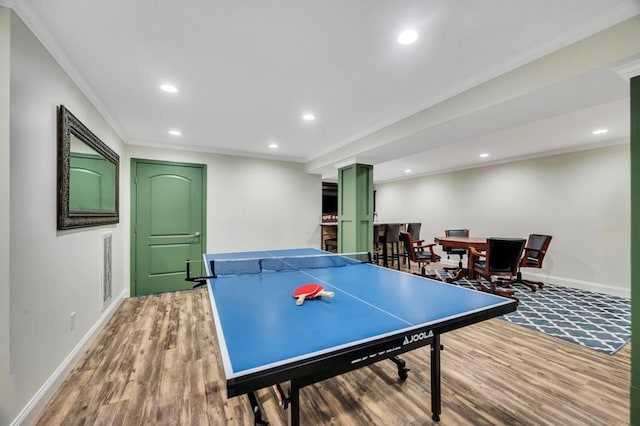 recreation room with crown molding and wood-type flooring