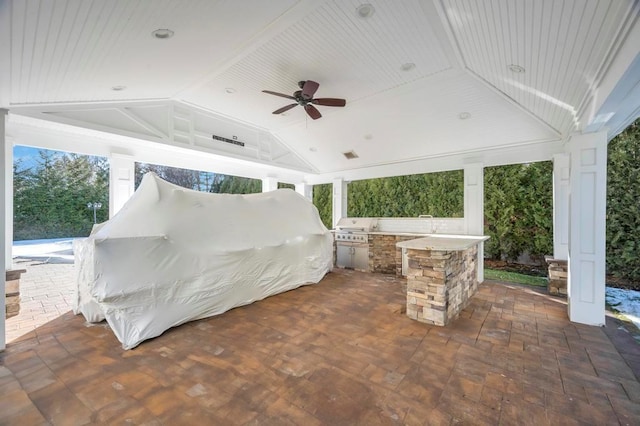 view of patio / terrace with exterior kitchen, a gazebo, area for grilling, and ceiling fan