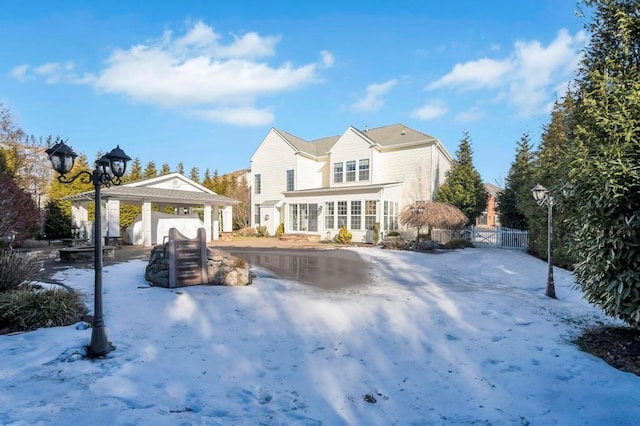 view of snow covered rear of property