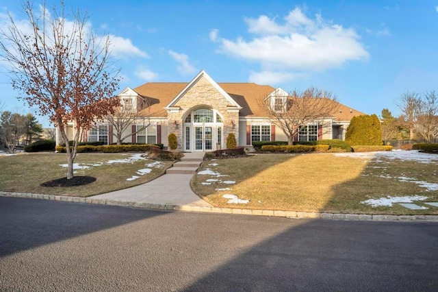 view of front of home with a front lawn and french doors