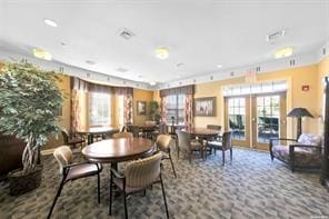 dining room with dark colored carpet