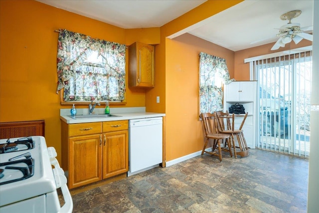 kitchen featuring ceiling fan, sink, and white appliances