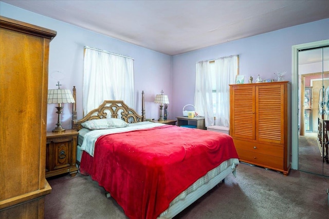 bedroom featuring dark colored carpet