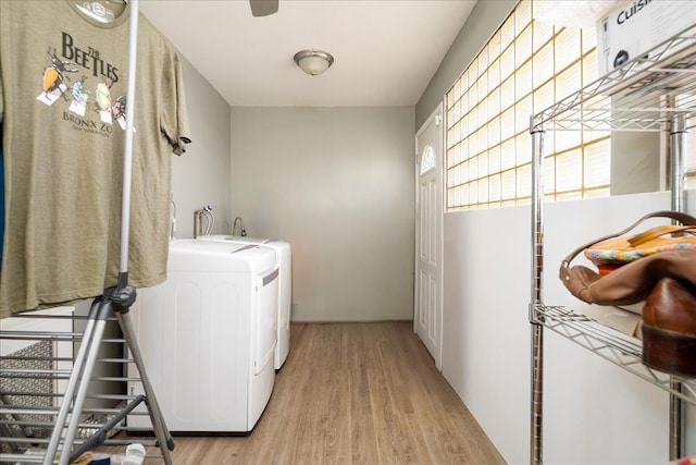 washroom featuring light hardwood / wood-style floors, a healthy amount of sunlight, and washing machine and clothes dryer