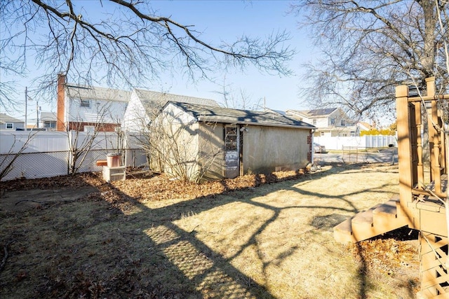 view of home's exterior with a lawn and a storage shed