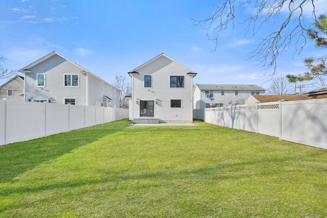 back of house featuring a lawn