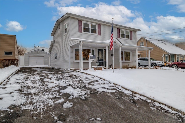 front of property with a garage, an outdoor structure, and a porch