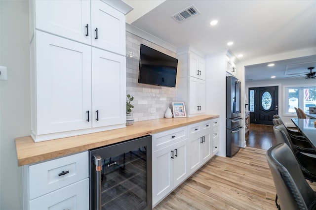 bar featuring white cabinetry, butcher block counters, and wine cooler