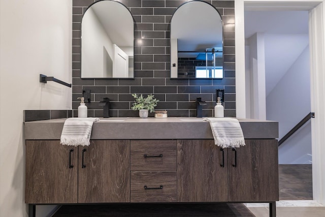 bathroom with decorative backsplash and vanity