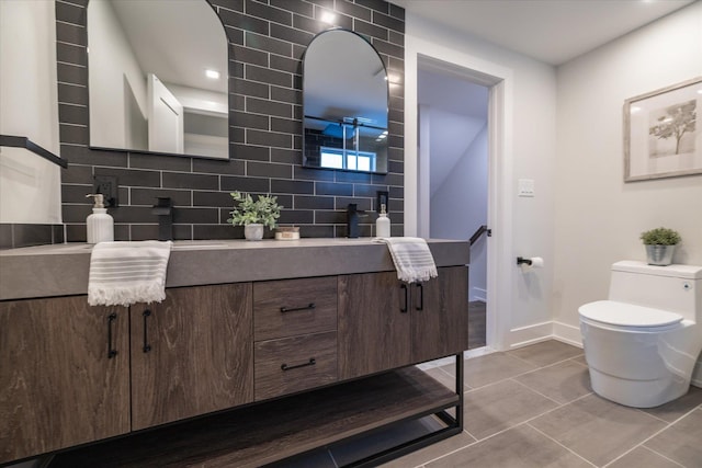 bathroom featuring vanity, toilet, tasteful backsplash, and tile patterned flooring