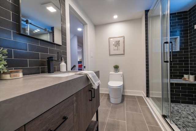 bathroom with toilet, vanity, tasteful backsplash, and walk in shower