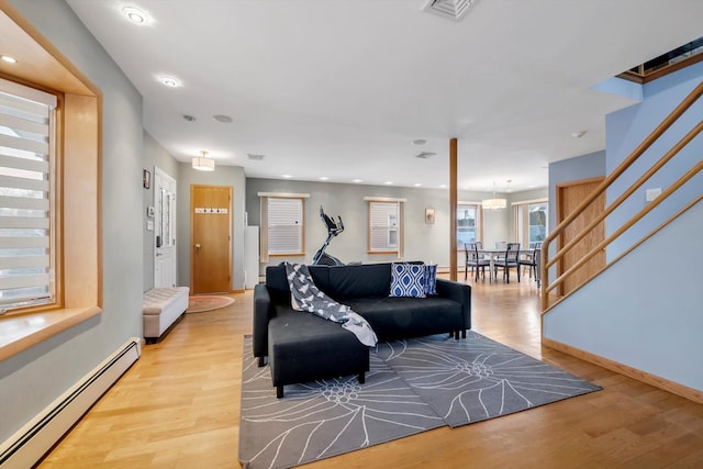 living room with a baseboard radiator and light hardwood / wood-style floors