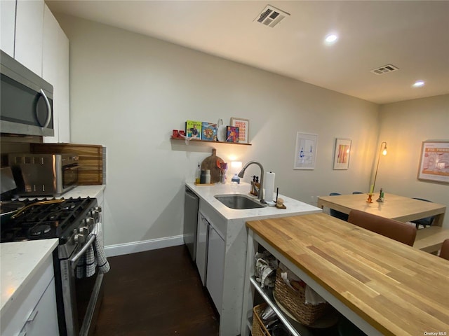 kitchen featuring sink, white cabinets, and appliances with stainless steel finishes