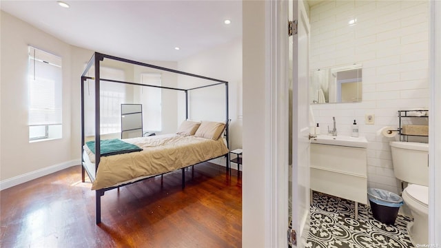 bedroom featuring hardwood / wood-style flooring and sink