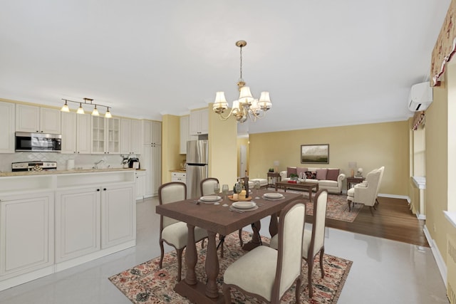 dining room featuring a wall mounted AC and a chandelier