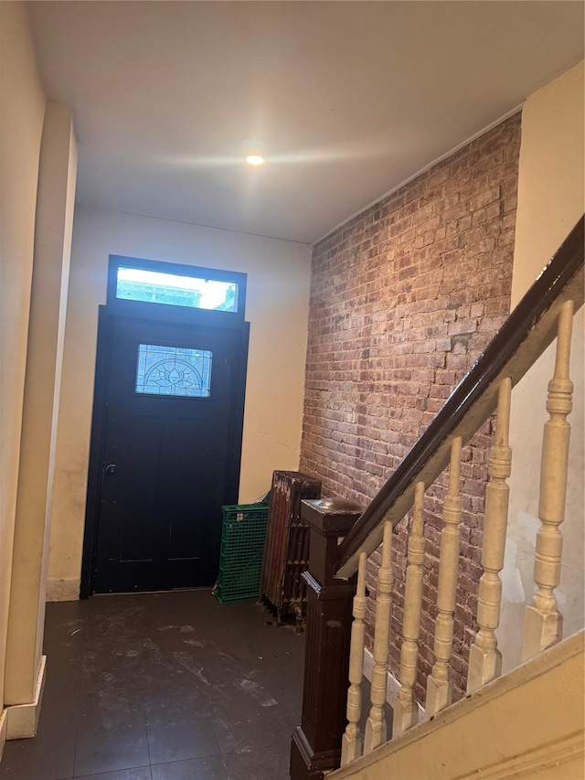 entryway with brick wall