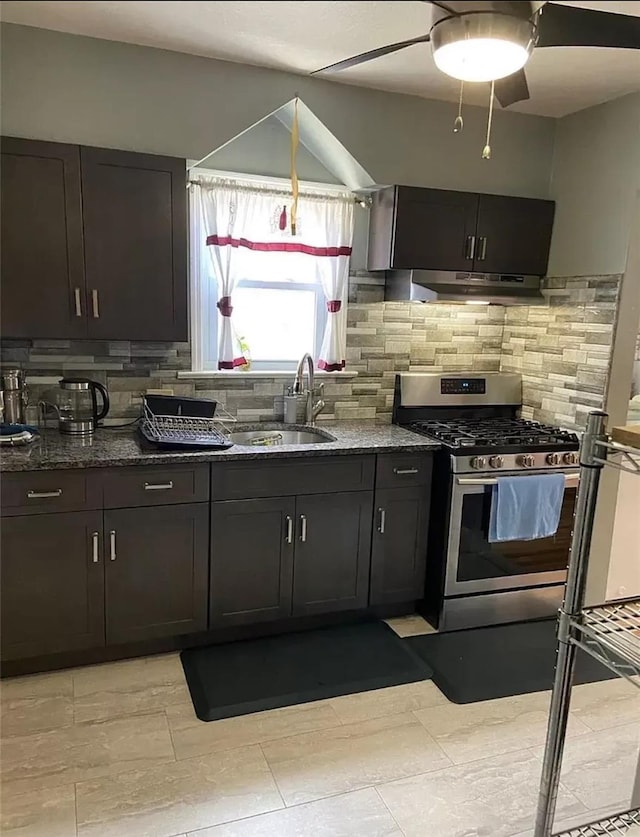 kitchen featuring sink, gas range, dark brown cabinets, and decorative backsplash