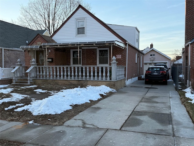 bungalow with an outbuilding, a porch, and a garage