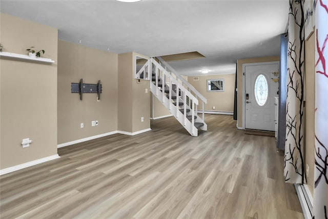 entrance foyer featuring light hardwood / wood-style floors and a baseboard heating unit