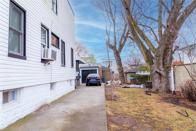 view of side of property featuring cooling unit and a garage