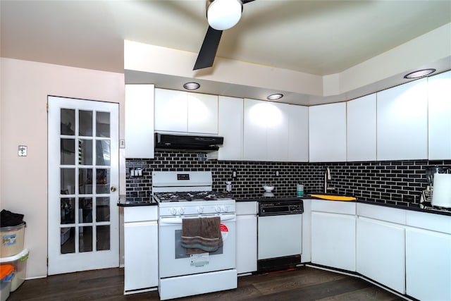 kitchen featuring extractor fan, white cabinetry, decorative backsplash, dark wood-type flooring, and white appliances