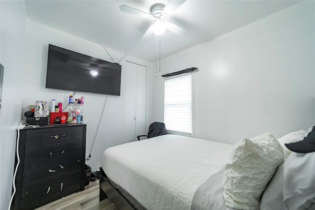 bedroom with ceiling fan, a closet, and light wood-type flooring