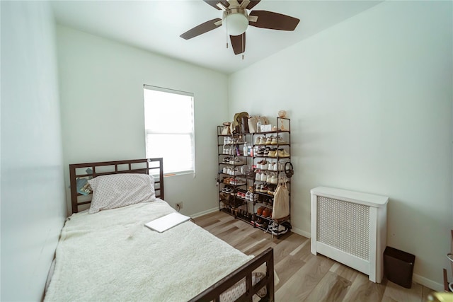 bedroom with light wood-type flooring and ceiling fan