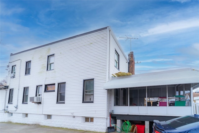 view of side of home with a sunroom