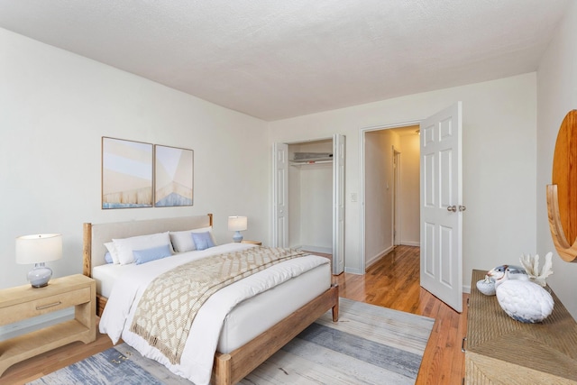 bedroom featuring hardwood / wood-style floors and a closet