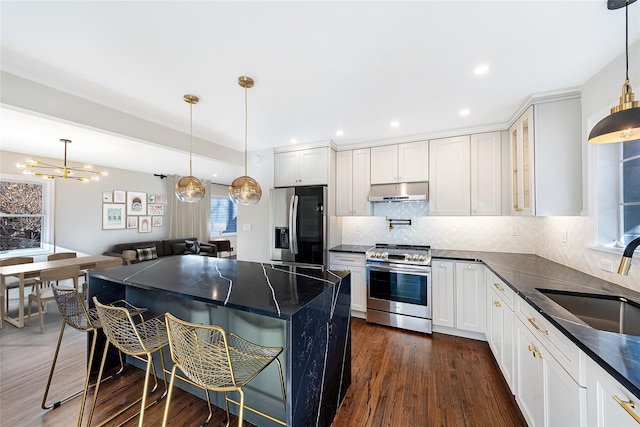 kitchen featuring sink, white cabinetry, pendant lighting, and stainless steel appliances