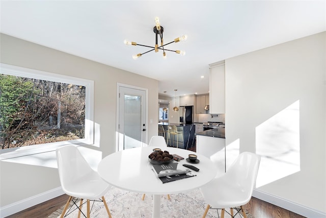 dining area featuring a chandelier and dark hardwood / wood-style flooring