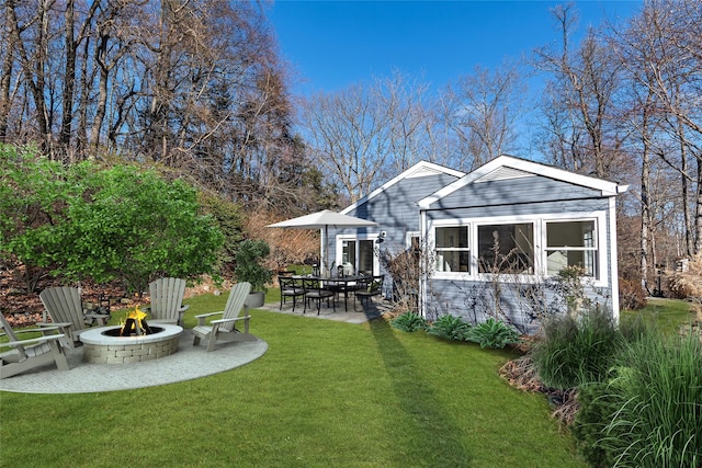 view of yard featuring a fire pit and a patio