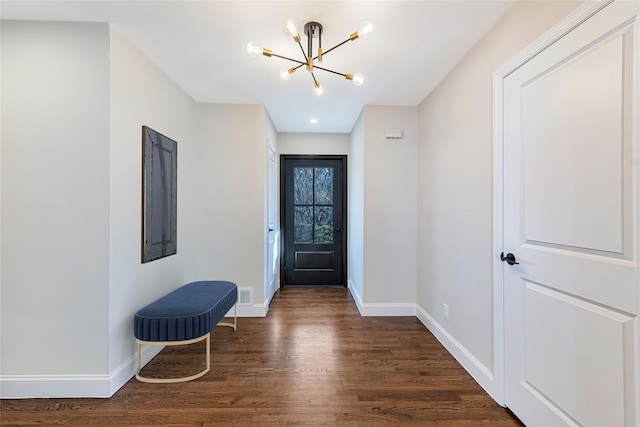 entrance foyer featuring a chandelier and dark hardwood / wood-style flooring