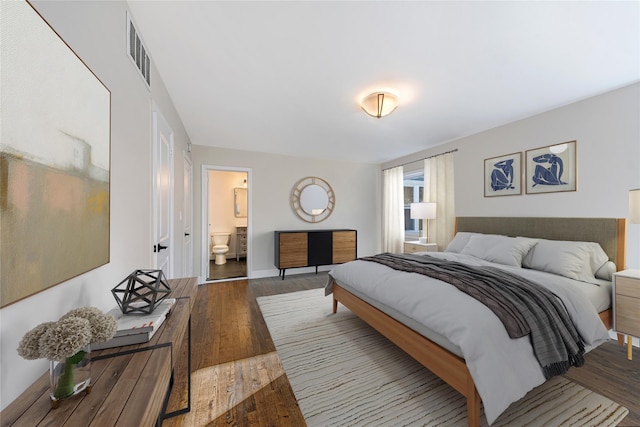 bedroom featuring ensuite bathroom and wood-type flooring