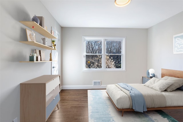 bedroom with dark hardwood / wood-style flooring