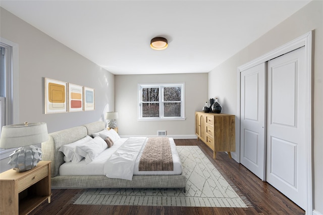 bedroom with a closet and dark hardwood / wood-style flooring