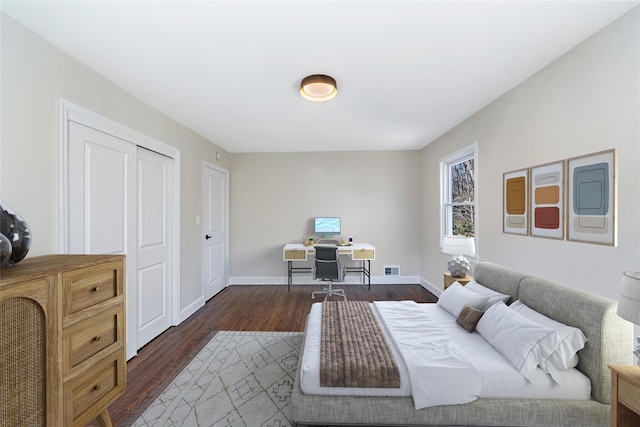 bedroom with dark hardwood / wood-style floors